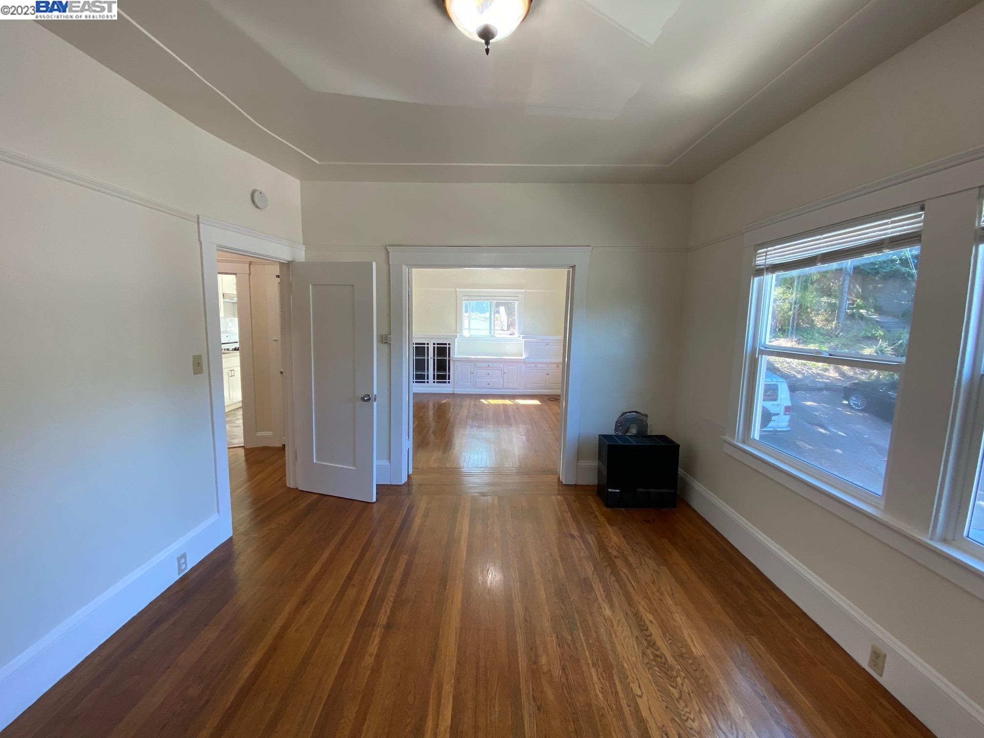 Ivy Hill Oakland, CA 94606 - Photo 18 of 19 wooden floor in an empty room with a window