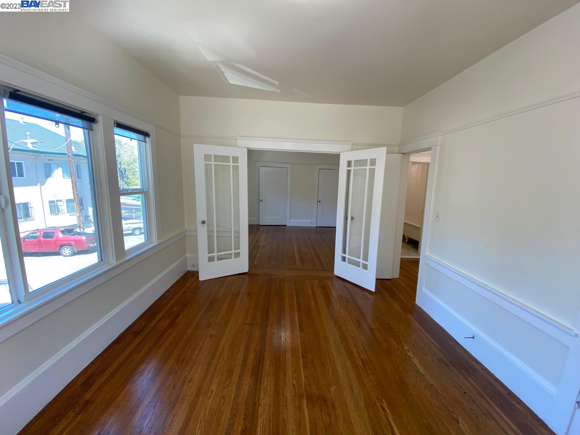 Ivy Hill Oakland, CA 94606 - Photo 19 of 19 a view of a big room with wooden floor and windows