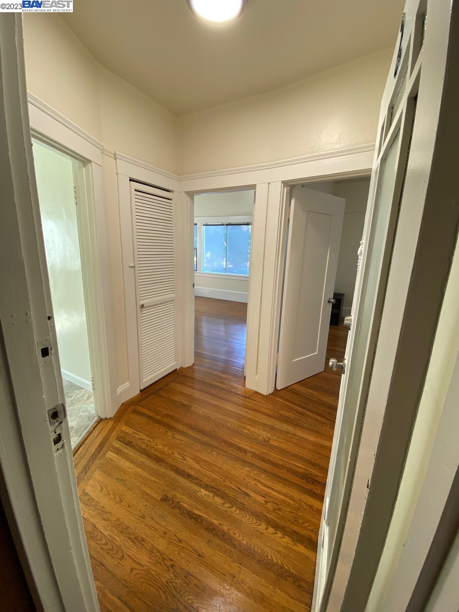 Ivy Hill Oakland, CA 94606 - Photo 3 of 19 a bedroom with a bed and wooden floor