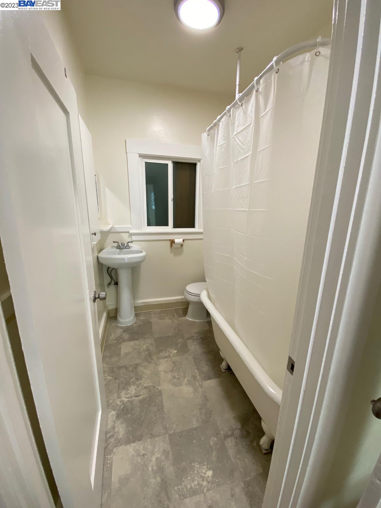 Ivy Hill Oakland, CA 94606 - Photo 8 of 19 a bath room with a toilet and a shower