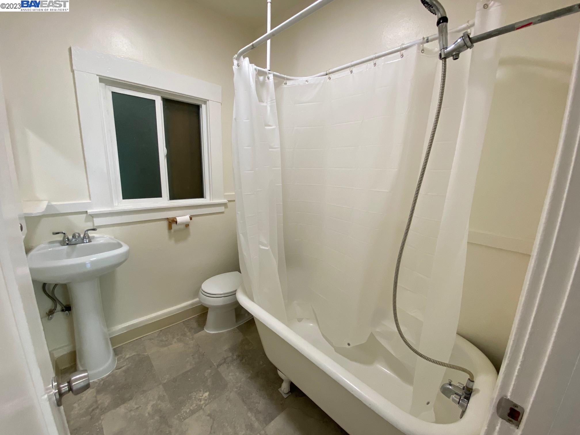 Ivy Hill Oakland, CA 94606 - Photo 9 of 19 a bathroom with a sink a toilet and shower