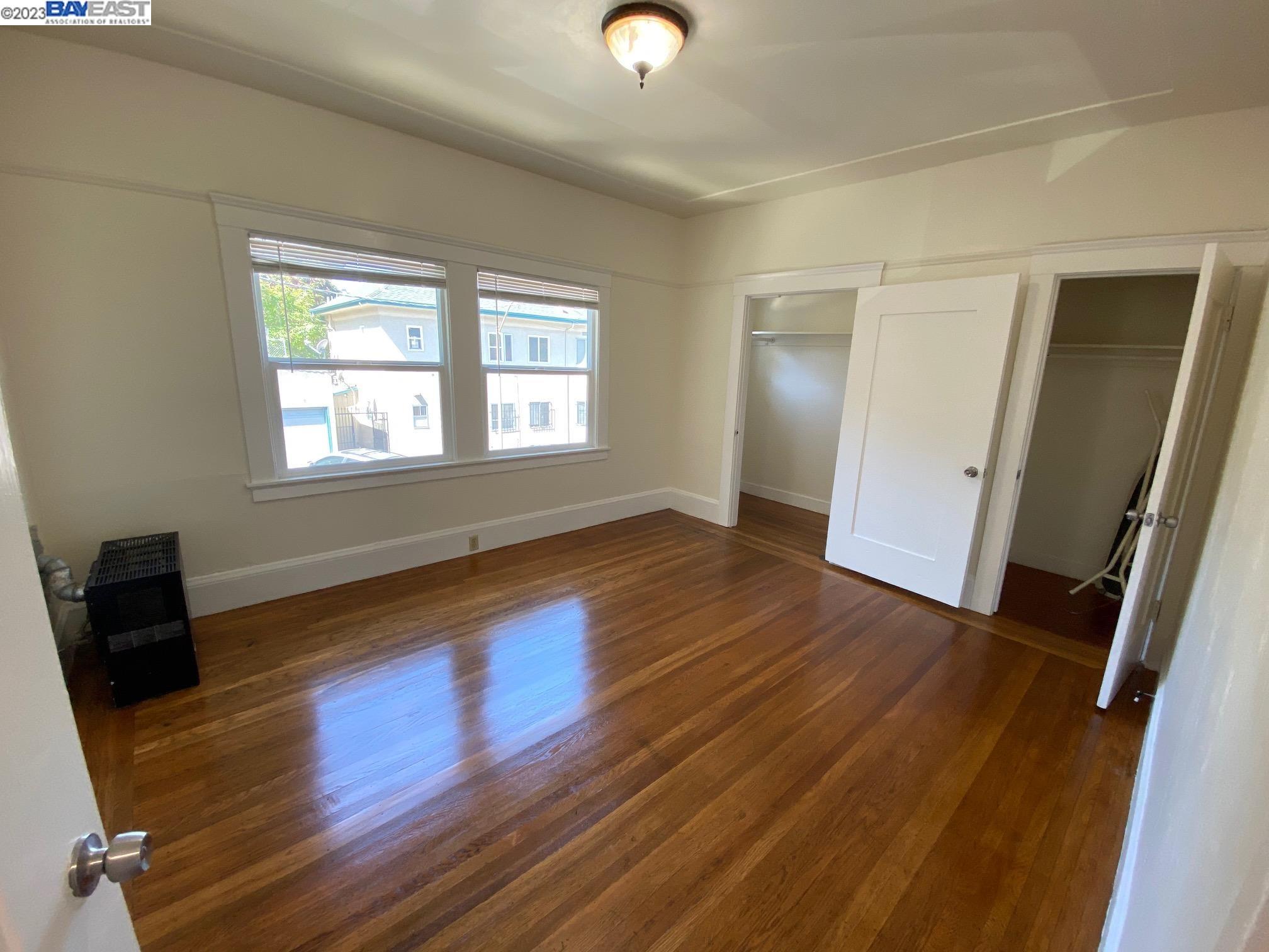 Ivy Hill Oakland, CA 94606 - Photo 10 of 19 wooden floor in an empty room with a window