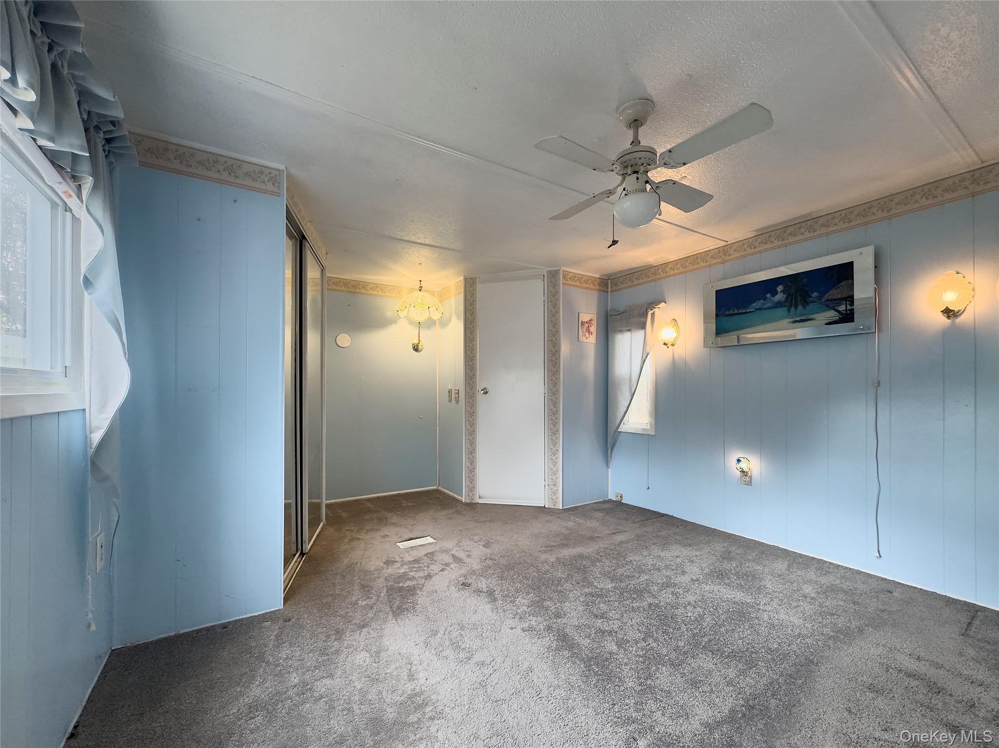 1964 River Road, Unit 55 Calverton, NY 11933 - Photo 8 of 13 a view of empty room with window and ceiling fan