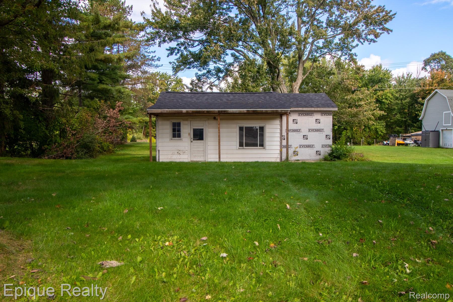 5831 Reed Street Deford, MI 48729 - Photo 2 of 11 View of outbuilding featuring view of wooded area