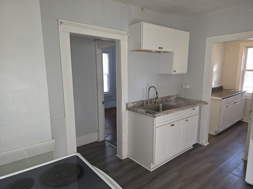 34 Qunicy, Unit 1 Springfield, MA 01109 - Photo 3 of 7 a kitchen with stainless steel appliances granite countertop a sink stove and cabinets