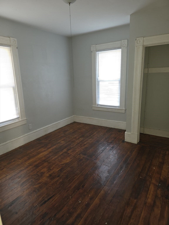 34 Qunicy, Unit 1 Springfield, MA 01109 - Photo 6 of 7 an empty room with wooden floor and windows