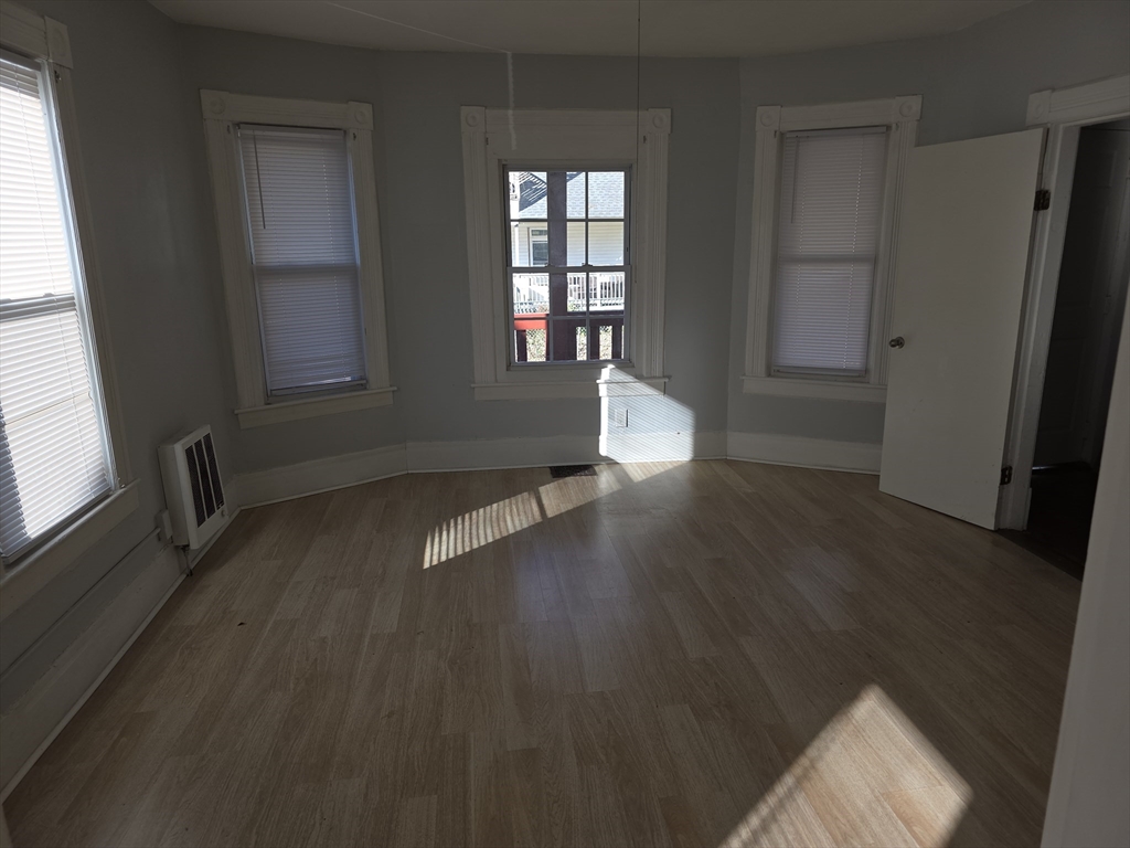 34 Qunicy, Unit 1 Springfield, MA 01109 - Photo 7 of 7 an empty room with wooden floor and windows