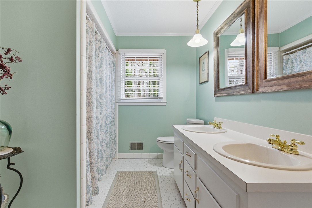 106 Cherokee Circle Anderson, SC 29621 - Photo 34 of 45 Dual vanities with gleaming brass fixtures and a clean, light ambiance define this refreshing bathroom space.