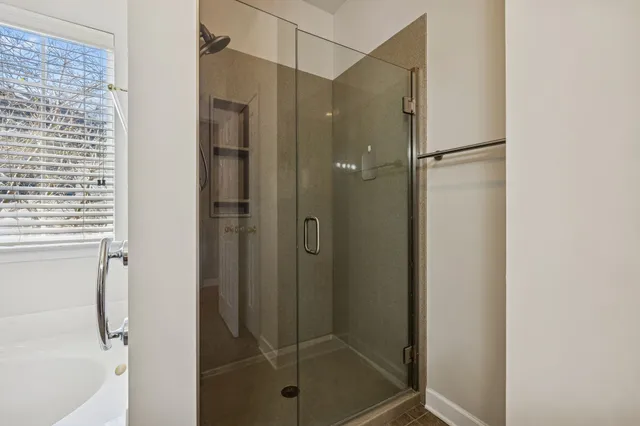 a bathroom with a glass shower door