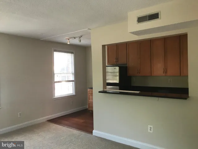 a view of kitchen with window and cabinets