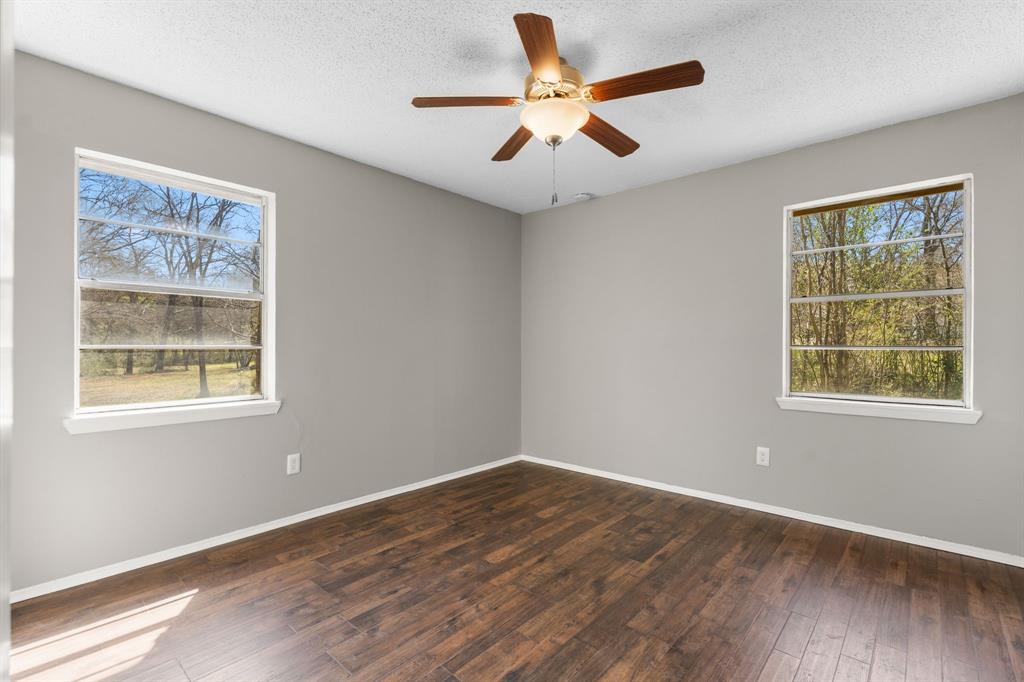 685 Sides Circle Canton, TX 75103 - Photo 16 of 32 a view of an empty room with wooden floor and a window