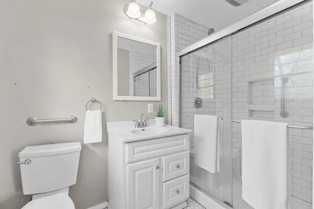 a bathroom with a toilet sink and mirror