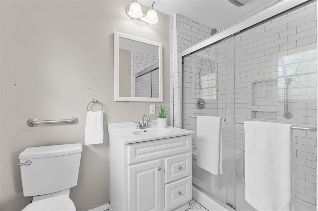 685 Sides Circle Canton, TX 75103 - Photo 18 of 32 a bathroom with a toilet sink and mirror