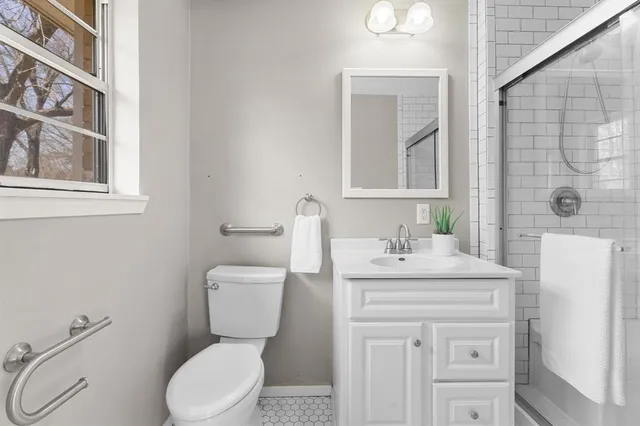 a bathroom with a sink a toilet and mirror