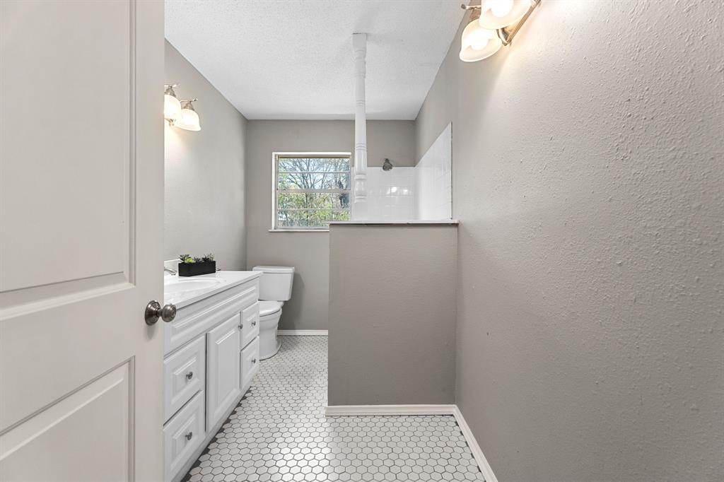 685 Sides Circle Canton, TX 75103 - Photo 25 of 32 a bathroom with a sink a vanity and a mirror