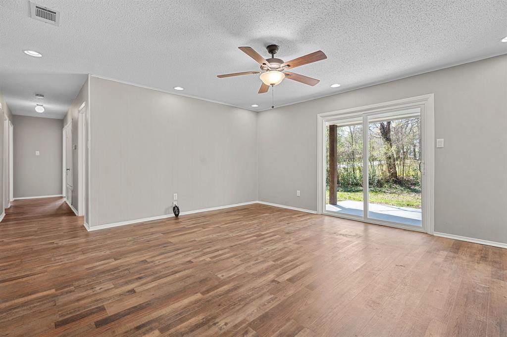 685 Sides Circle Canton, TX 75103 - Photo 8 of 32 a view of an empty room with wooden floor and a window