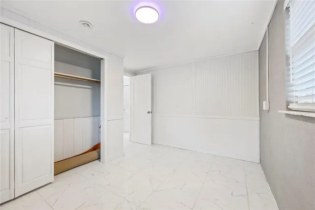 a view of a closet area with wooden floor