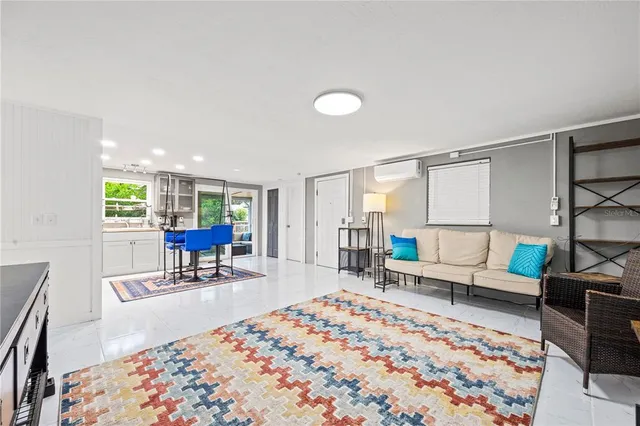 a bedroom with a bed and a dresser next to a window