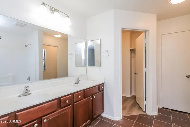 a bathroom with a double vanity sink and a mirror