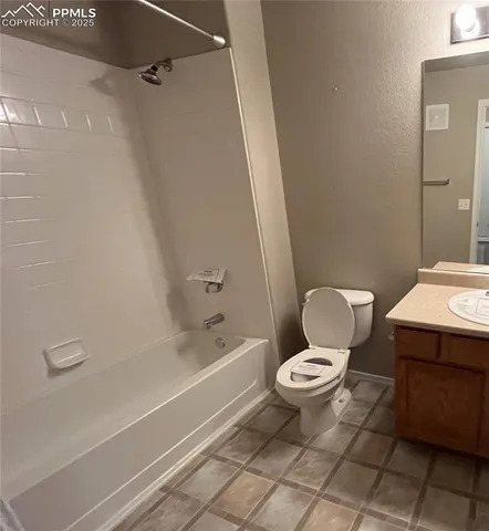 a white toilet sitting next to a bath tub