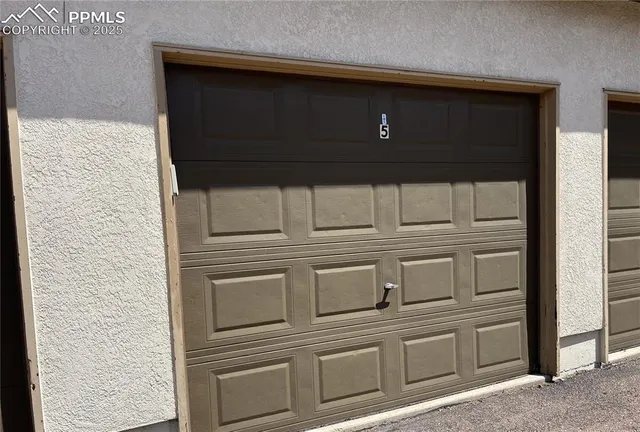 a kitchen with white cabinets and black appliances