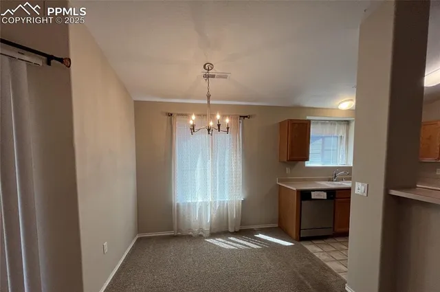 a view of a kitchen with a sink and cabinet area