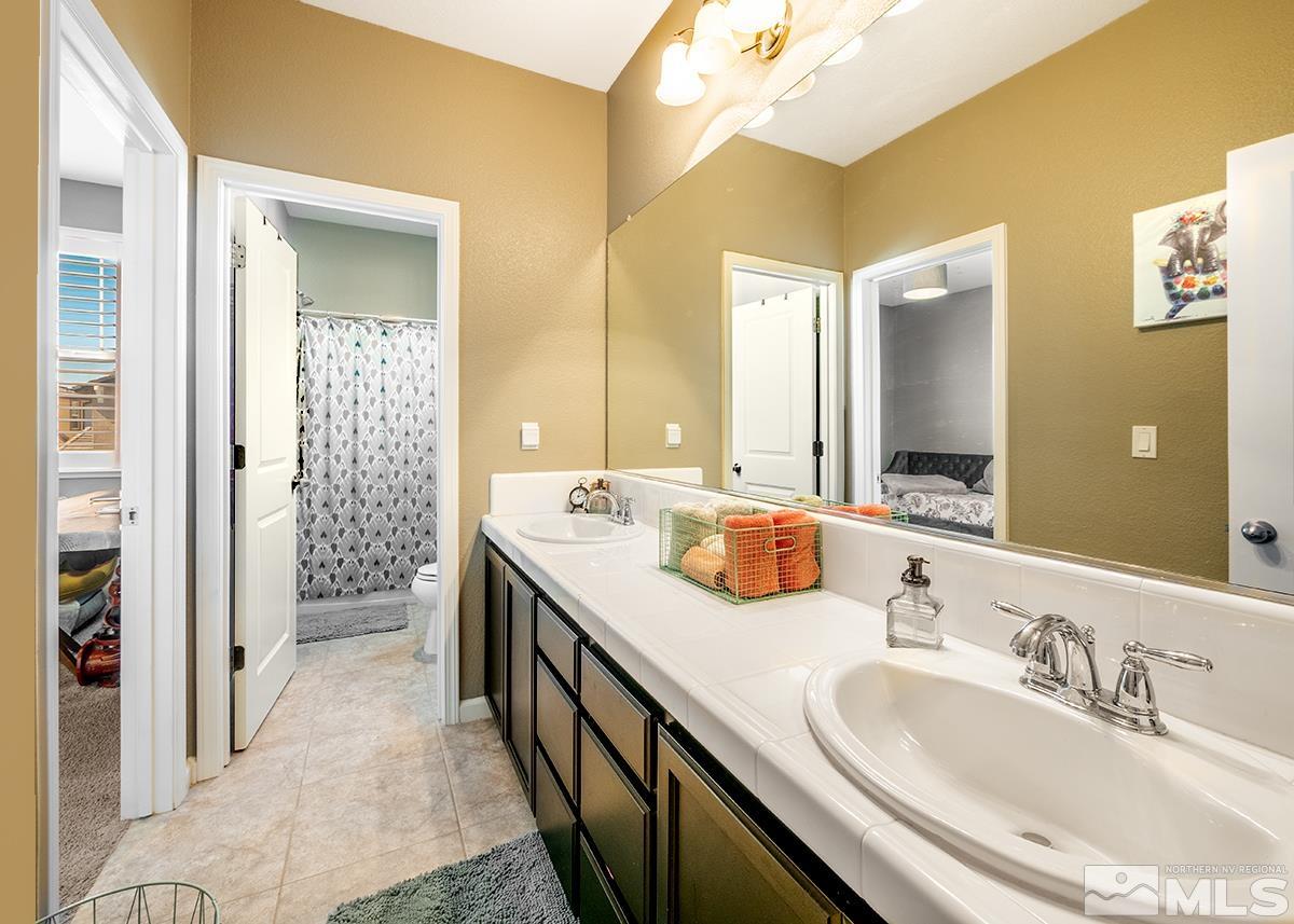 1990 Hope Valley Drive Reno, NV 89521 - Photo 12 of 22 a en suite bathroom with a double vanity sink and a mirror