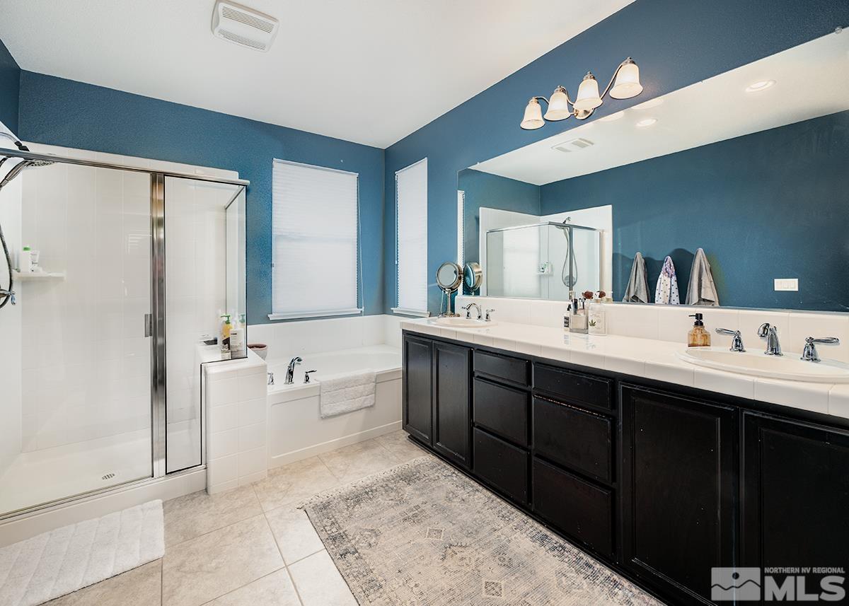 1990 Hope Valley Drive Reno, NV 89521 - Photo 17 of 22 a spacious bathroom with a double vanity sink a mirror and a bathtub