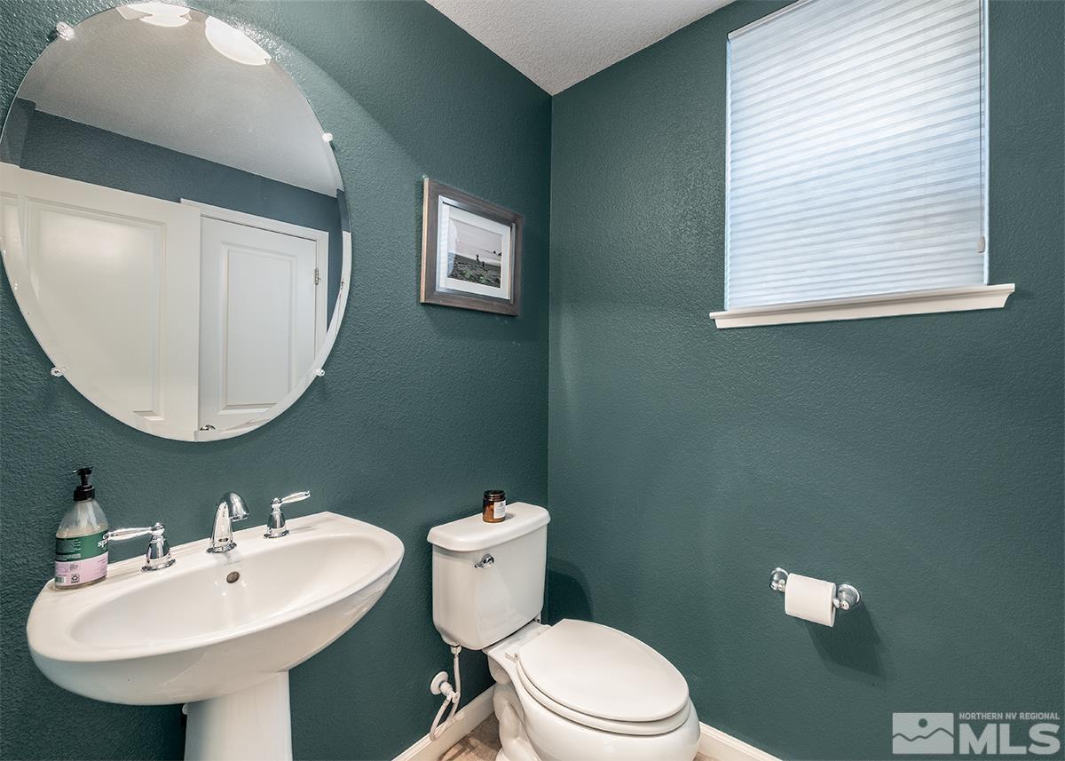 1990 Hope Valley Drive Reno, NV 89521 - Photo 10 of 22 a bathroom with a toilet a sink and mirror