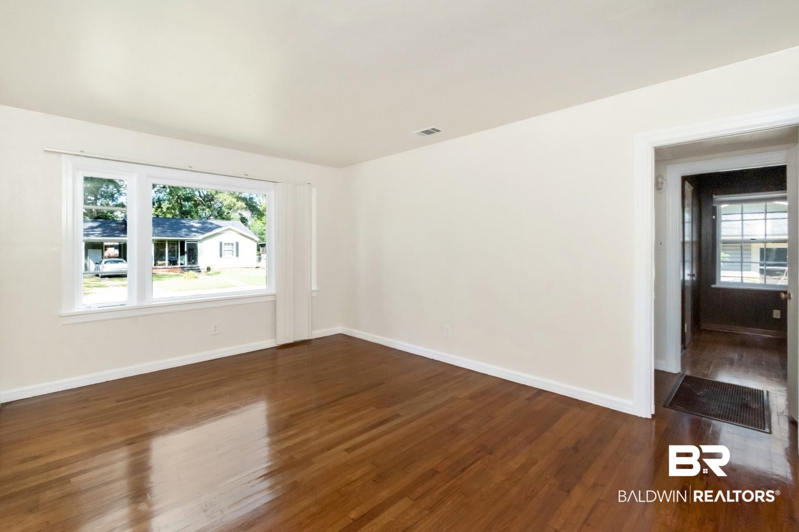 1477 Fairfield Street Mobile, AL 36606 - Photo 9 of 34 Spare room with dark wood-style floors and baseboards