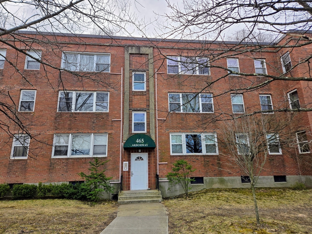 465 Arborway, Unit 13 Boston, MA 02130 - Photo 1 of 41 front view of a brick house with a yard