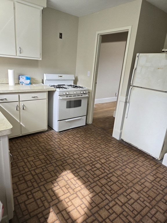465 Arborway, Unit 13 Boston, MA 02130 - Photo 12 of 41 a kitchen with a sink and a stove