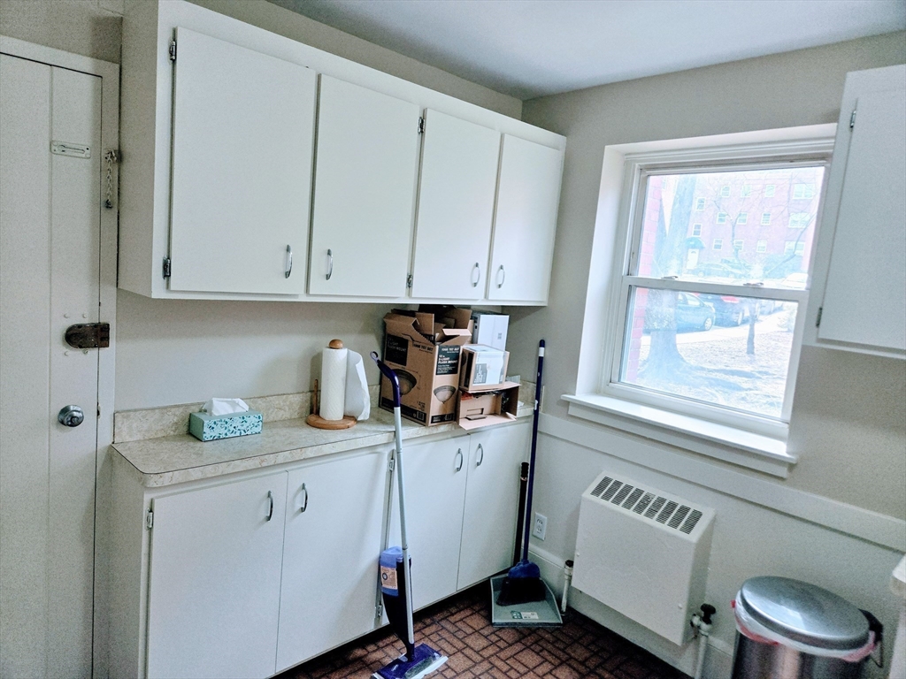 465 Arborway, Unit 13 Boston, MA 02130 - Photo 14 of 41 a kitchen with stainless steel appliances a cabinets and a window