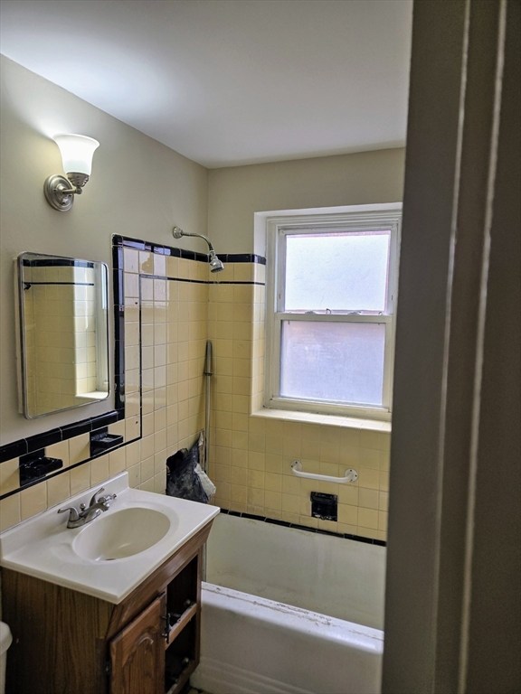 465 Arborway, Unit 13 Boston, MA 02130 - Photo 21 of 41 a bathroom with a sink and a mirror