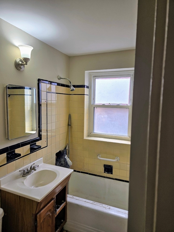 465 Arborway, Unit 13 Boston, MA 02130 - Photo 22 of 41 a bathroom with a sink and a mirror