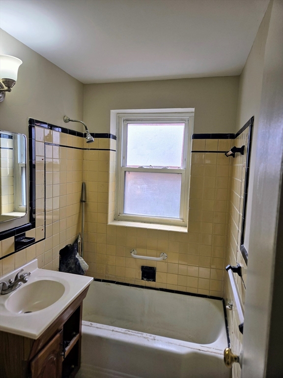 465 Arborway, Unit 13 Boston, MA 02130 - Photo 23 of 41 a bathroom with a sink and a bathtub