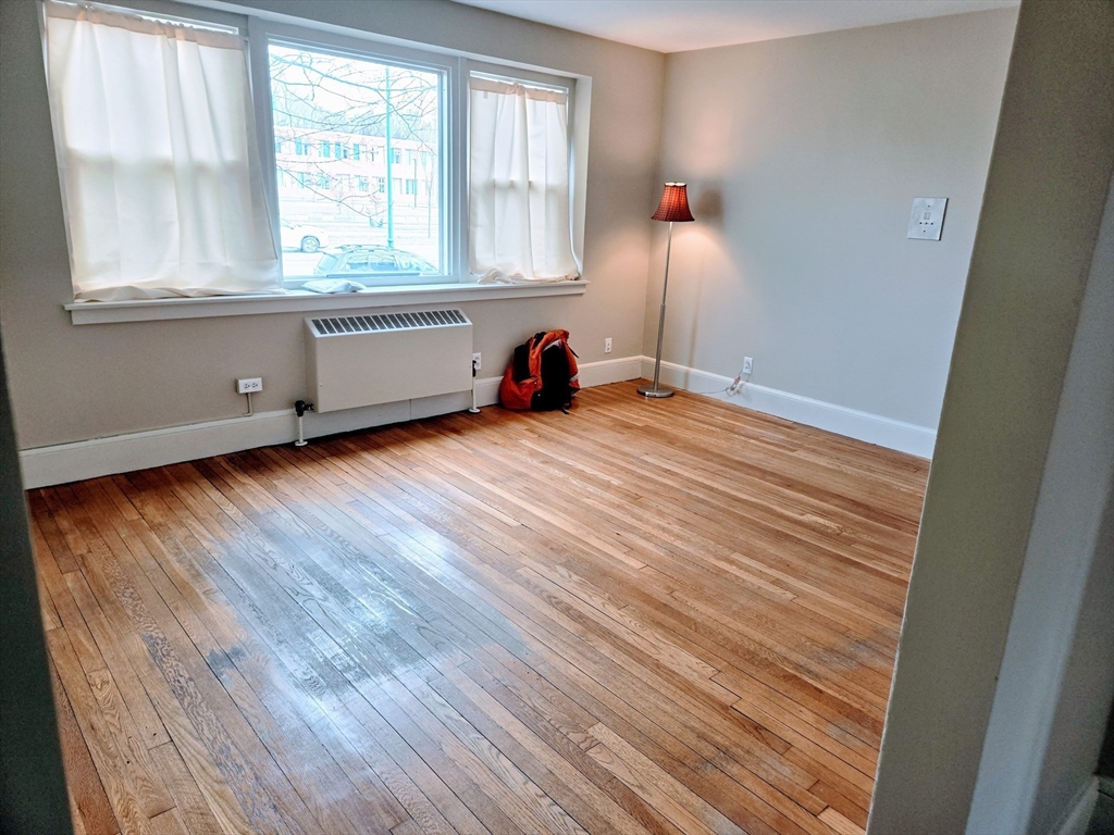 465 Arborway, Unit 13 Boston, MA 02130 - Photo 24 of 41 a view of a room with wooden floor and fan
