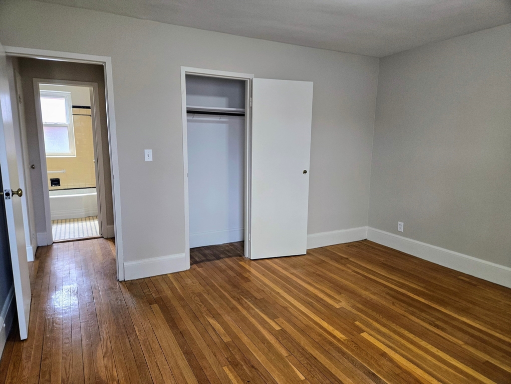465 Arborway, Unit 13 Boston, MA 02130 - Photo 31 of 41 a view of an empty room and wooden floor