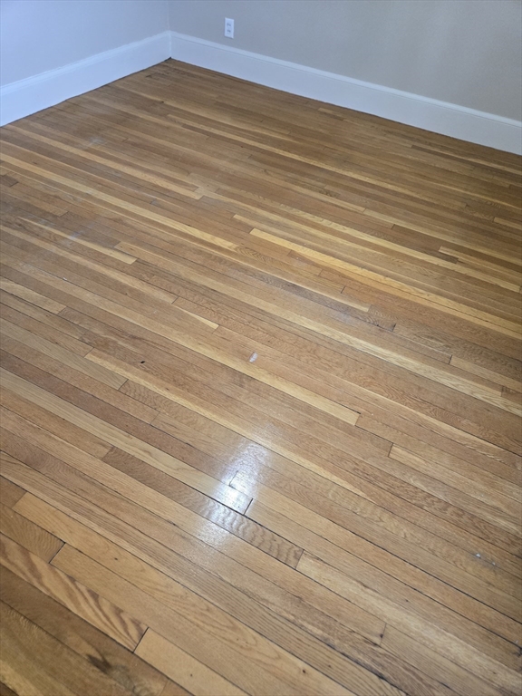 465 Arborway, Unit 13 Boston, MA 02130 - Photo 32 of 41 a view of a room with wooden floor