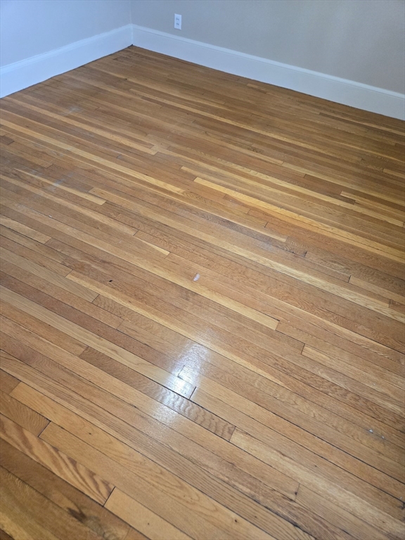 465 Arborway, Unit 13 Boston, MA 02130 - Photo 35 of 41 a view of a room with wooden floor