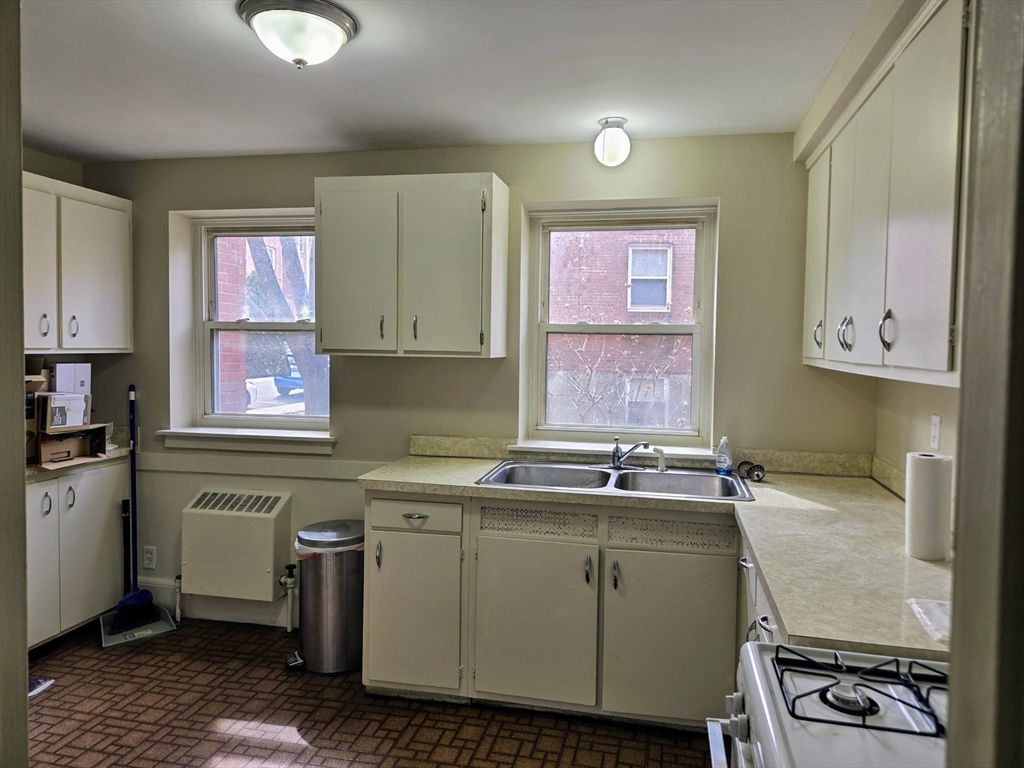 465 Arborway, Unit 13 Boston, MA 02130 - Photo 10 of 41 a kitchen with a sink cabinets and window