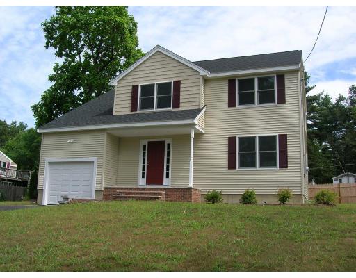 9 Cypress Road Groton, MA 01450 - Photo 1 of 13 a front view of a house with a yard