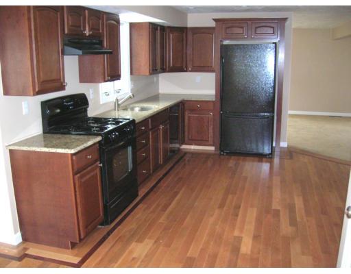 9 Cypress Road Groton, MA 01450 - Photo 2 of 13 a kitchen with stainless steel appliances granite countertop a stove a refrigerator and a wooden cabinets