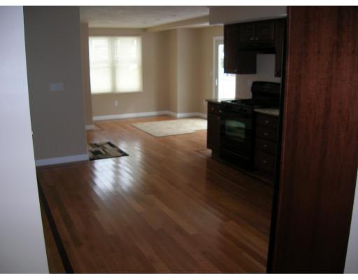 9 Cypress Road Groton, MA 01450 - Photo 4 of 13 a kitchen with granite countertop white cabinets and wooden floor