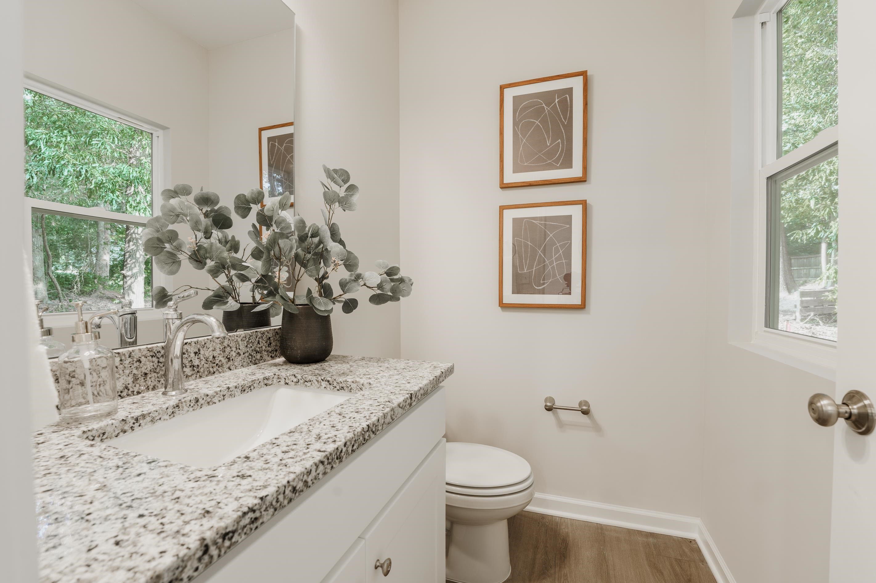 1309 Swingline Way Raleigh, NC 27610 - Photo 15 of 47 a bathroom with a granite countertop sink a large mirror and a window