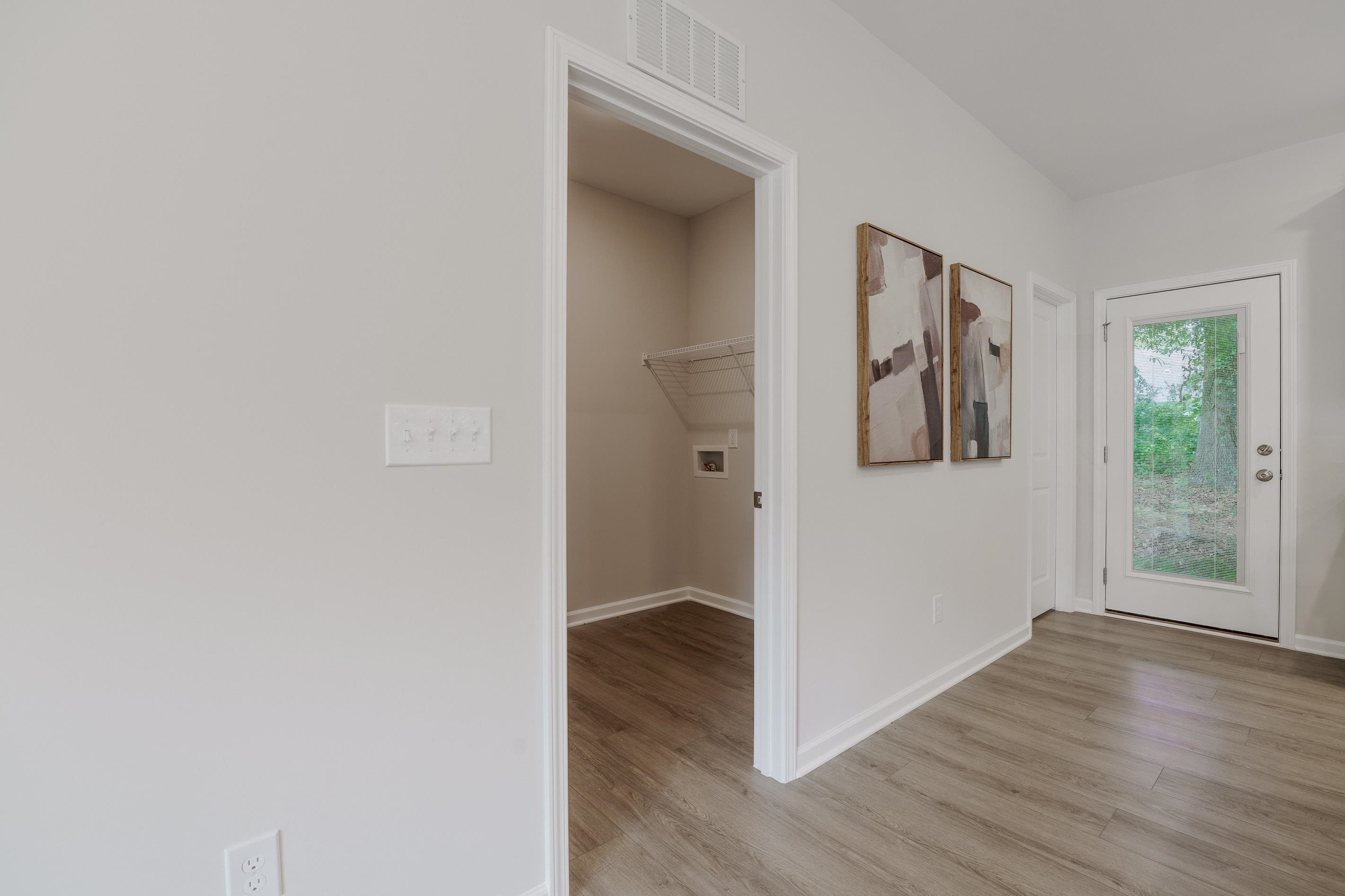 1309 Swingline Way Raleigh, NC 27610 - Photo 16 of 47 a view of a hallway with wooden floor and a window