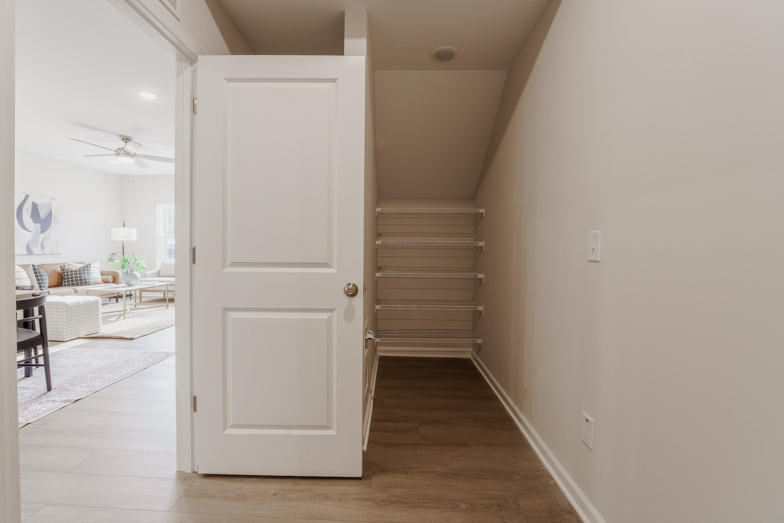 1309 Swingline Way Raleigh, NC 27610 - Photo 18 of 47 a view of a hallway with wooden floor and furniture