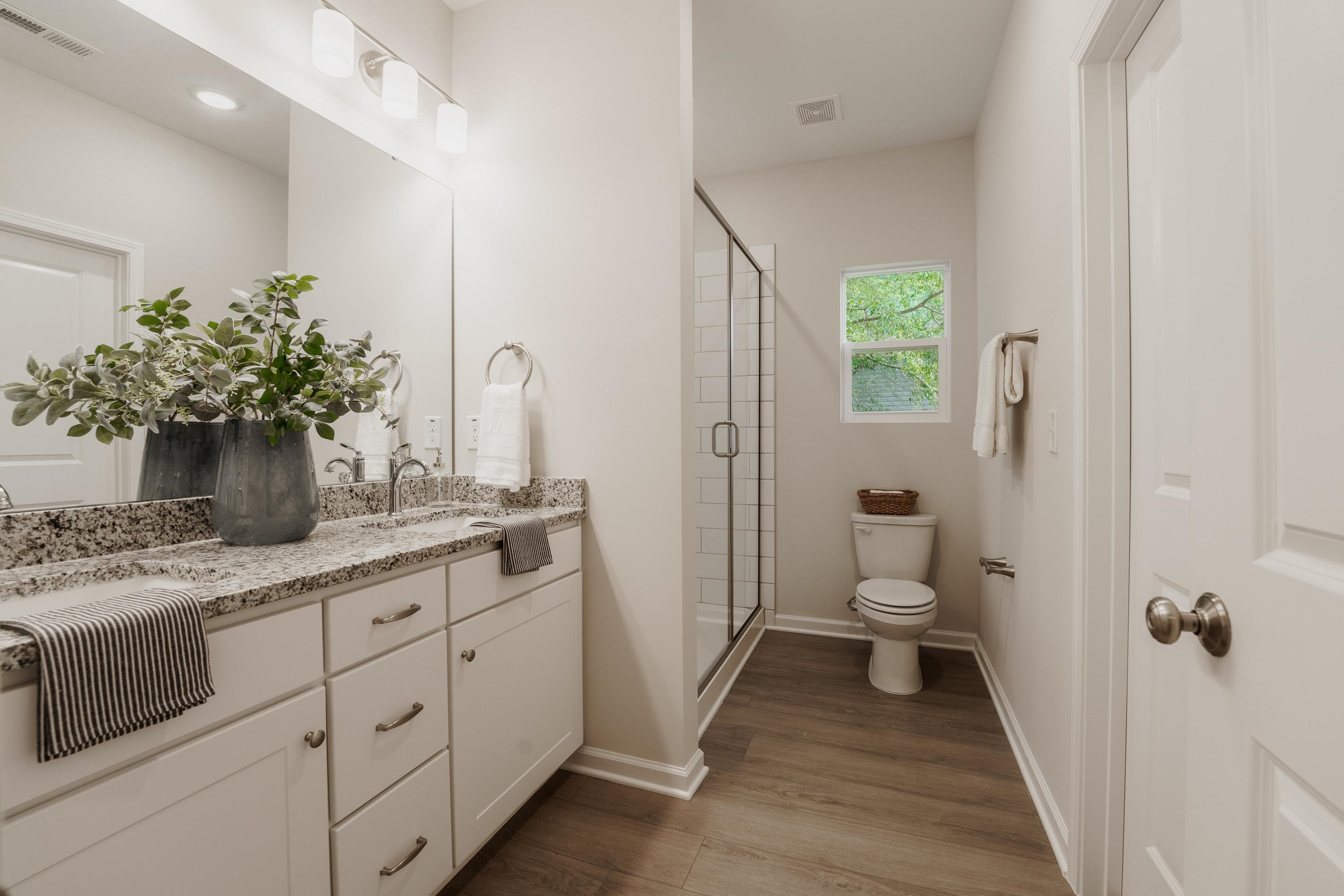 1309 Swingline Way Raleigh, NC 27610 - Photo 32 of 47 a bathroom with a granite countertop sink toilet and shower