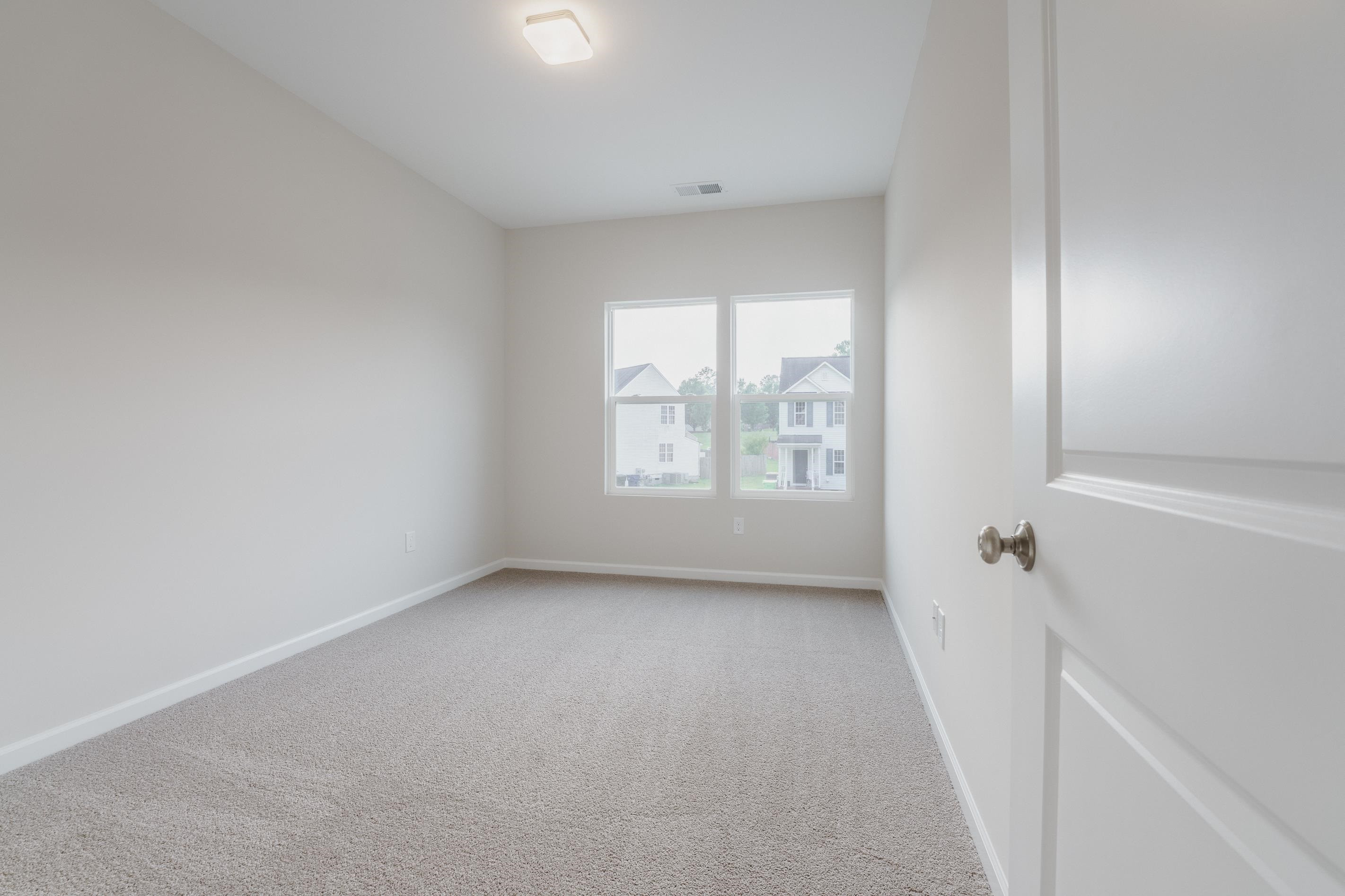 1309 Swingline Way Raleigh, NC 27610 - Photo 38 of 47 an empty room with windows