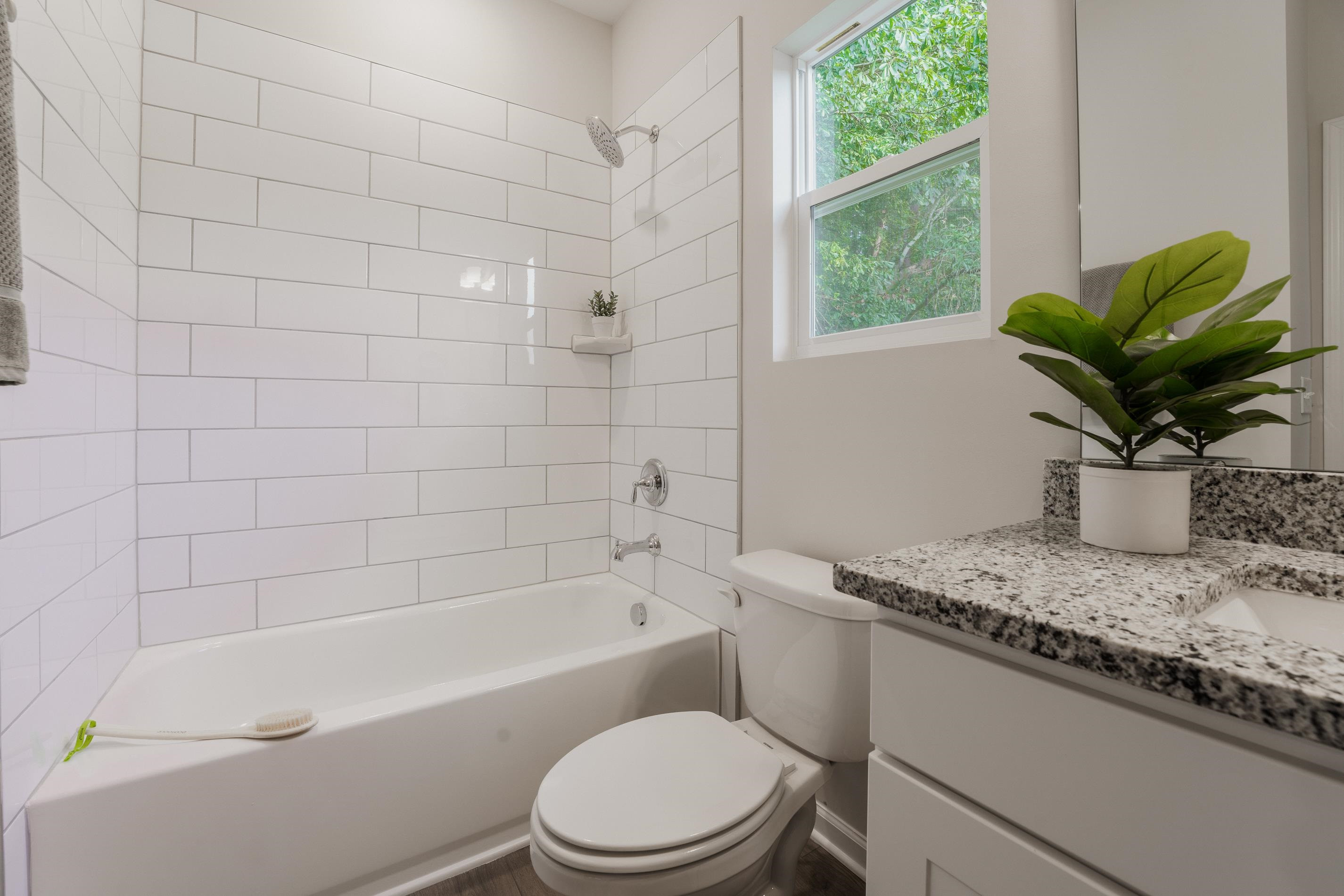 1309 Swingline Way Raleigh, NC 27610 - Photo 40 of 47 a white toilet sitting next to a bath tub